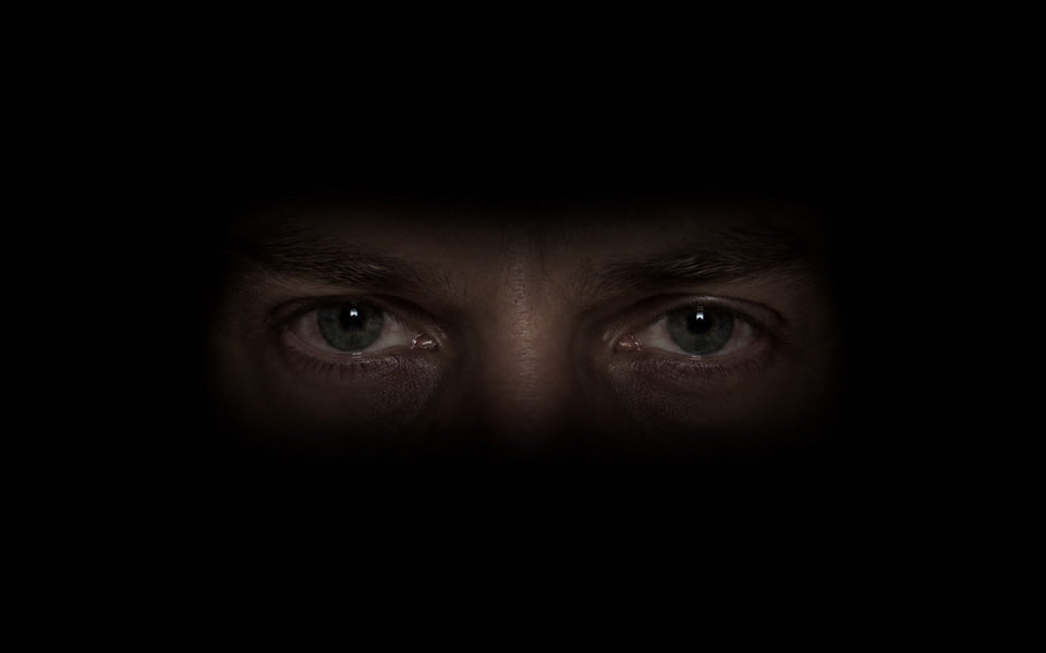The Watcher: eyes emerge from a dark screen.
